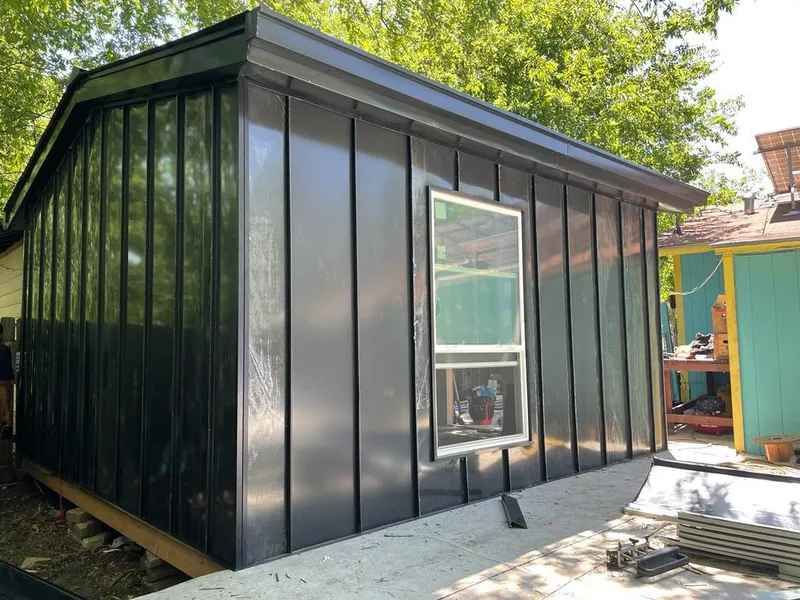 Black standing seam metal wall panels for Roof Inspection in Geddes